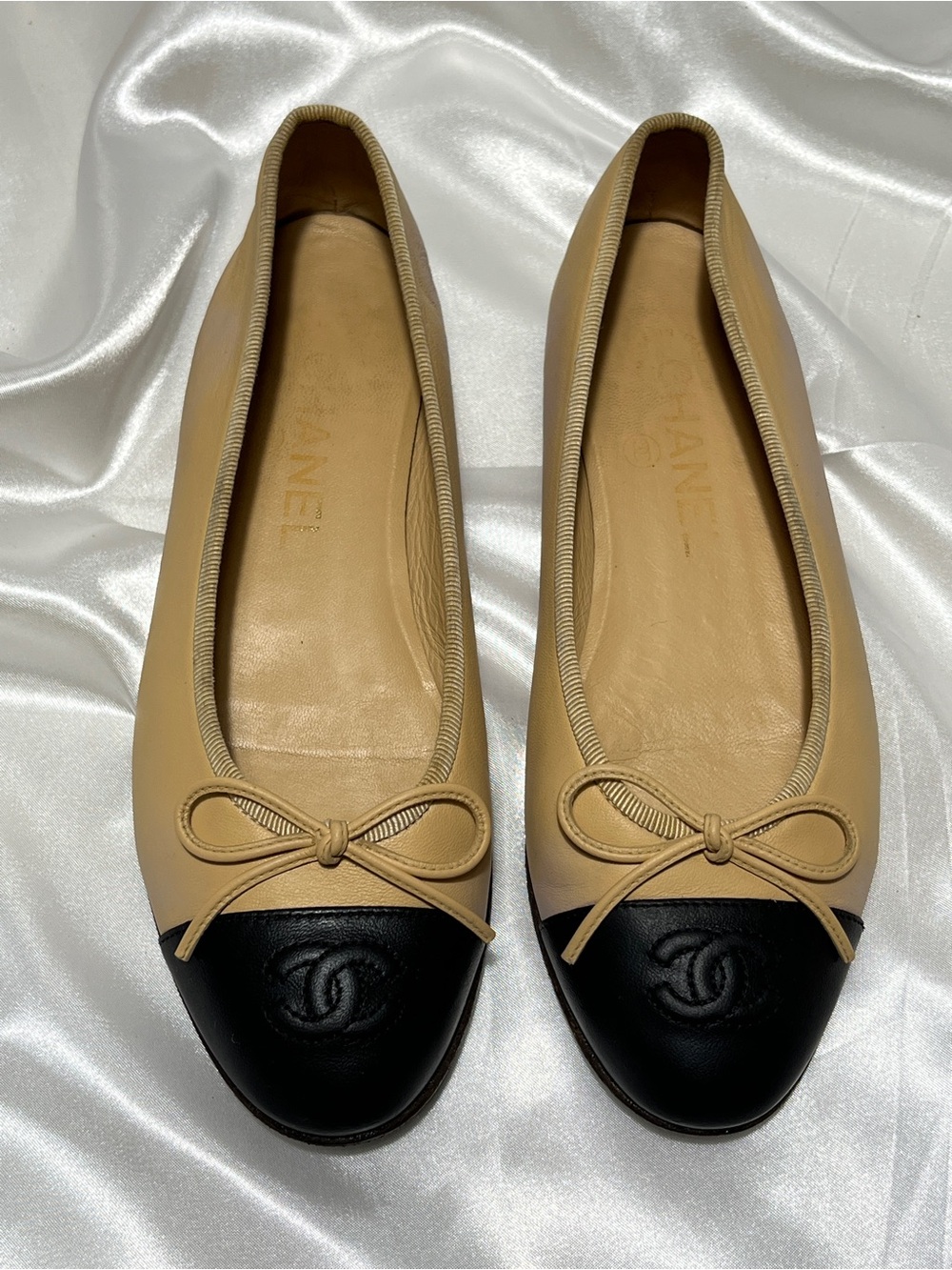 CHANEL Beige Leather Ballet Flats with Black Cap Toe and CC Logo